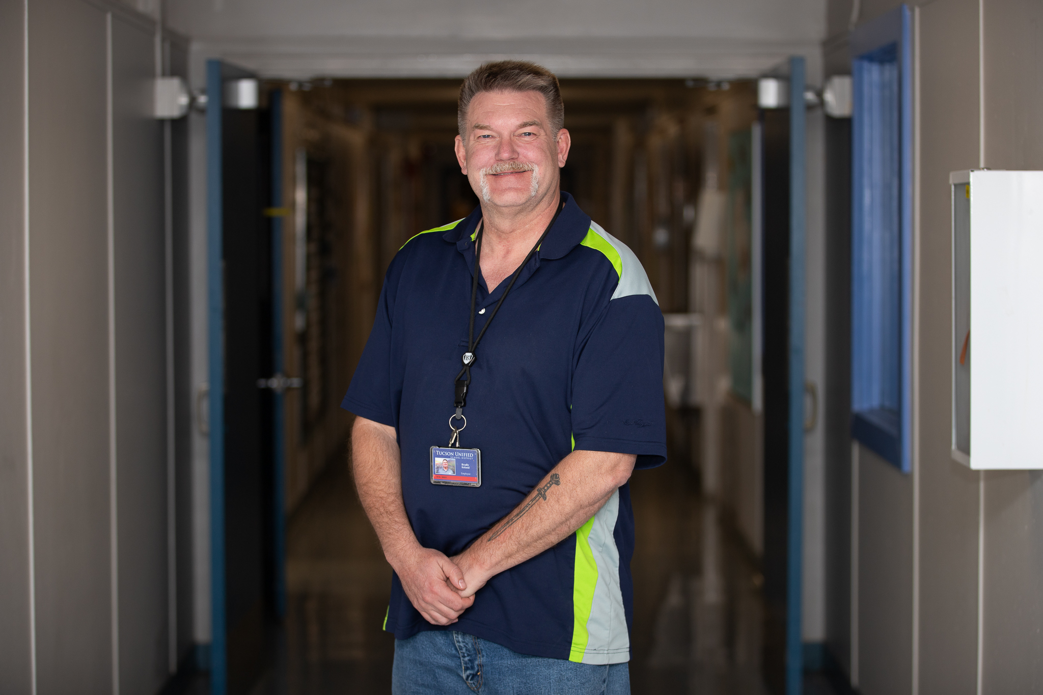 A man smiles in the school hallway