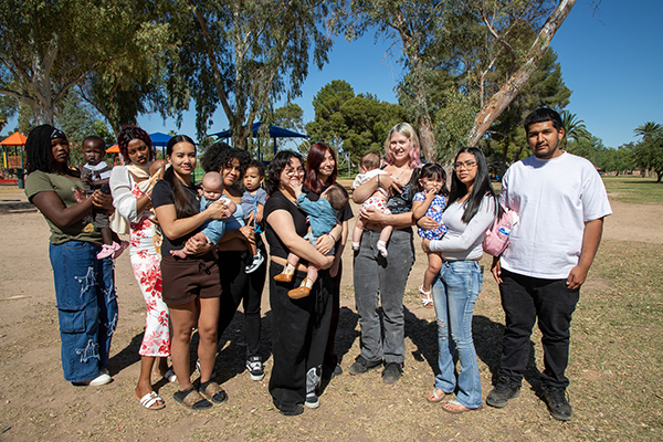 A group of TAP students and their babies in the park